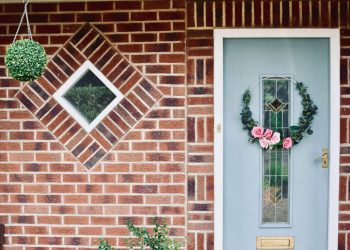 Аранжирана с цветя бяла входна врата